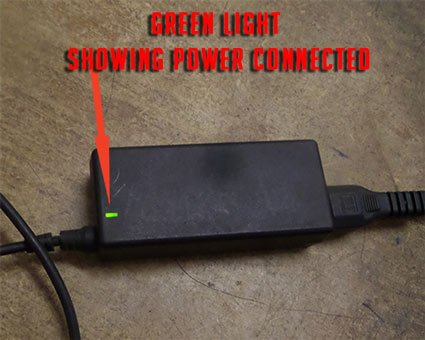 Dell laptop charger green light indicating that its connected to power working power supply