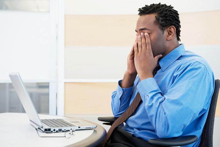 Man with aching eyes because of computer strain